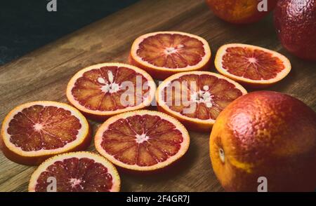 Red jucy oranges round sliced, close-up, shallow depth of field, stylized Stock Photo