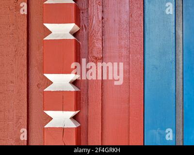 Traditional Scandinavian wooden architecture detail, red, blue and white painted wood wall Stock Photo