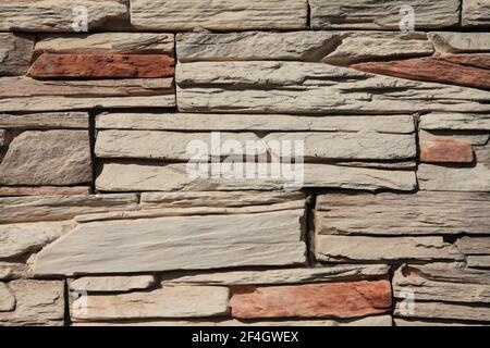 Decorative wall texture, background. Stone cladding in different colors grungy and matted stone bricks. The fragment of a new decorative stone laying Stock Photo