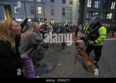 A police officer with a police dog faces protesters outside Bridewell Police Station as they take part in a 'Kill the Bill' protest in Bristol, demonstrating against the Government's controversial Police and Crime Bill. Picture date: Sunday March 21, 2021.