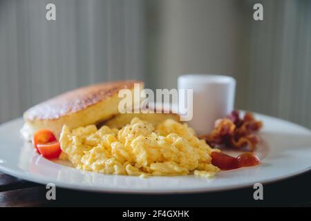 scramble egg with pancake and bacon breakfast food in film vintage style Stock Photo