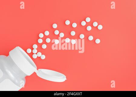 topview of methyl folate tablets flying from the jar. dietary concept. dietary supplement close-up Stock Photo