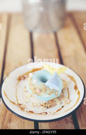 Fancy donut with cute mermaid on top Stock Photo