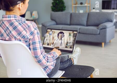 Young woman with laptop computer video calling online doctor of telemedicine clinic Stock Photo
