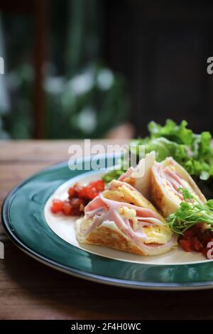 Breakfast burrito ham and eggs with salad vintage style Stock Photo