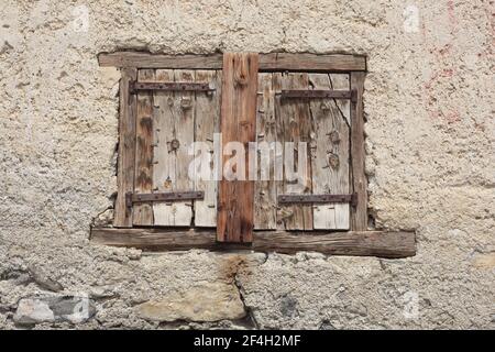 wooden shutters on the stone wall Stock Photo