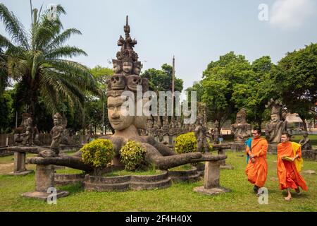 Novice Buddhist monks at Xieng Khuan Buddha Park, a sculpture park by the Mekong River near Vientiane, Laos. Stock Photo