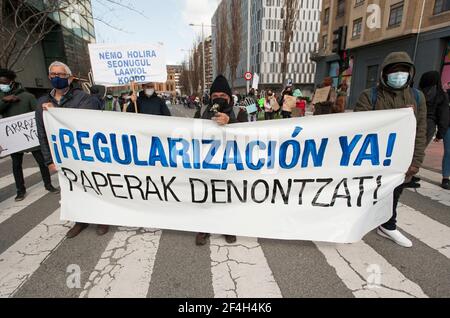 Pamplona, Spain. 21st Mar, 2021. Demonstrators hold a large banner during the demonstration.Demonstrators take to the streets of Pamplona on the occasion of the celebration of the International Day for the Elimination of Racial Discrimination. (Photo by Elsa A Bravo/SOPA Images/Sipa USA) Credit: Sipa USA/Alamy Live News Stock Photo