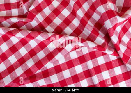 Traditional white and red kitchen chekered towel rustic style for a picnic or tablecloth with tartan pattern. Gingham crampled texture for table Stock Photo