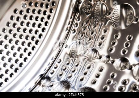 The metal drum of the new washing machine is close-up. Household appliances Stock Photo