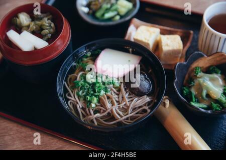 Soba noodles with soup on wood background Stock Photo