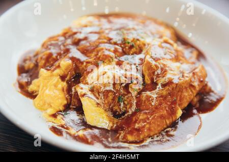 Curry rice with omelette Japanese style on wood background film vintage style Stock Photo