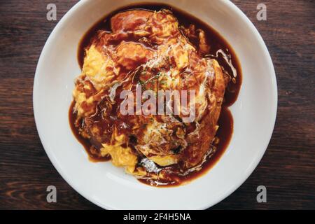 Curry rice with omelette Japanese style on wood background film vintage style Stock Photo