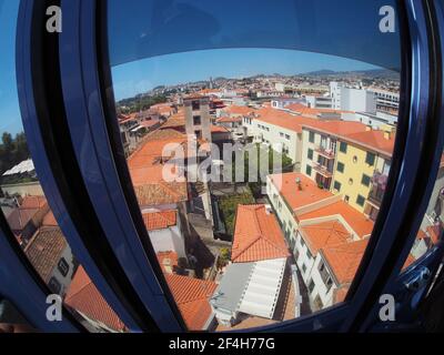 Madeira, Portugal. 09,05,2017    View of the rooftops of the houses of Funchal from the Funchal cable car cabin, starting the descent to the city. Stock Photo