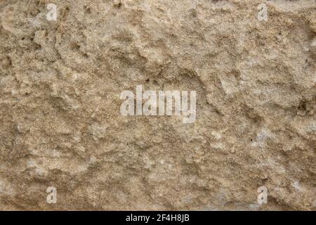 texture of yellow rough stone. Abstract background from yellow stone wall Stock Photo