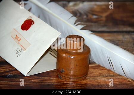 Old vintage handwritten letter with inkwell and feather Stock Photo