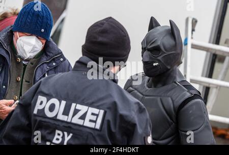 Munich, Bavaria, Germany. 21st Mar, 2021. A man dressed as Batman at the Gemeinsame Zukunft demo in Munich who was told by police that the costume violated the anti-disguising laws for demos. The Gemeinsame Zukunft group headed by Susanna Grill of Cocoon Hotels held a demonstration at Munich's Theresienwiese calling for an end to the lockdown politics of Germany and reasonable anti-Corona measures. Despite the requests for 1,000 'reasonable people'' to be there, the group had less than 100, with many known from the Querdenken/Corona Rebel and neonazi/NPD members, far-right/conspiracy me Stock Photo