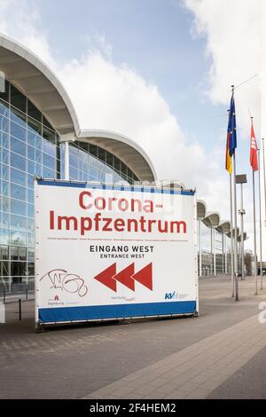 Sign showing directions for the Corona vaccination center, west entrance (on German: 'Corona Impfzentrum, Eingang West') center in Hamburg Messehallen Stock Photo