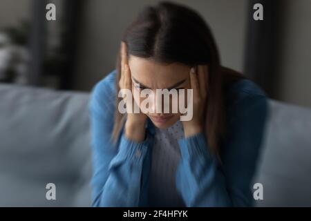Close up unhappy woman suffering from strong headache and dizziness Stock Photo