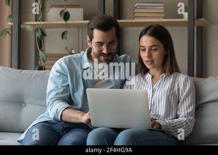 Close up happy young couple enjoying leisure time with laptop Stock Photo