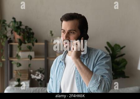 Close up man talking on phone, enjoying pleasant conversation Stock Photo