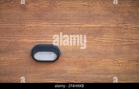 detail of a beacon or signaling light on a concrete wall with wood color and texture Stock Photo