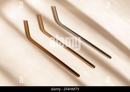 https://l450v.alamy.com/450v/2f4hmt9/reusable-zero-waste-metal-straw-eco-friendly-drinking-straws-from-aluminium-or-stainless-steel-on-neutral-beige-background-with-shadow-from-room-2f4hmt9.jpg