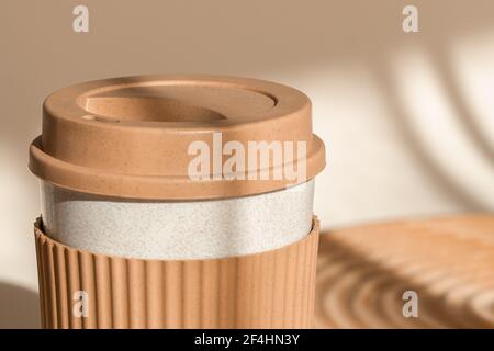 Reusable cup, biodegradable travel plastic coffee mug take away. Bamboo eco friendly cup. Zero waste, sustainability concept. Close up view Stock Photo