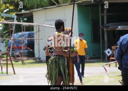 A male dancer with his spear escorting guests at Divine Word University's graduation ceremony in 2021. Stock Photo