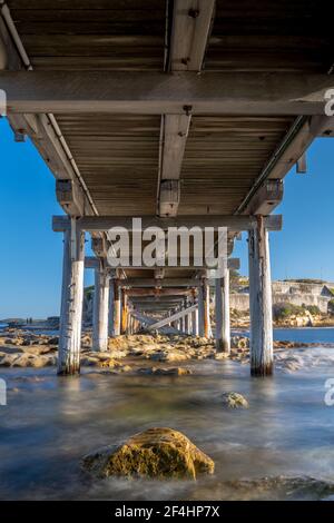 Long exposure water under a bridge at Maroubra, Sydney, Australia Stock Photo