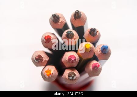 Colourful children's drawing pencils pointing up with colourful pattern that resembles a rainbow Stock Photo