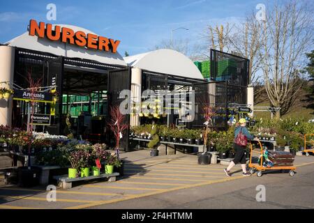 A shopper leaving the nursery department in the Home Depot in Tigard, Ore., on March 13, 2021, as springtime approaches amid the pandemic. Stock Photo