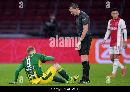 AMSTERDAM, NETHERLANDS - MARCH 21: Jonas Arweiler of ADO Den Haag and referee Allard Lindhout during the Eredivisie match between Ajax and ADO Den Haa Stock Photo