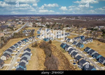 Aerial perspective of double rows of luxury single family homes intersecting and forming an X shape in a new real estate development community in the Stock Photo