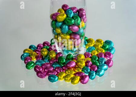 Easter celebration concept. Glass vase with chocolate candies. Stock Photo