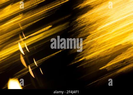 Abstract illuminating golden lights on a black background Stock Photo