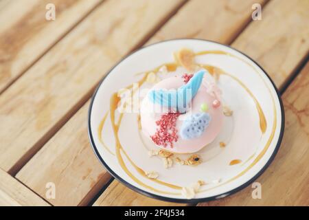 Fancy donut with cute mermaid on top Stock Photo