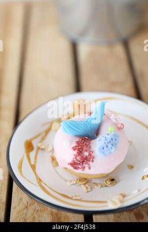 Fancy donut with cute mermaid on top Stock Photo