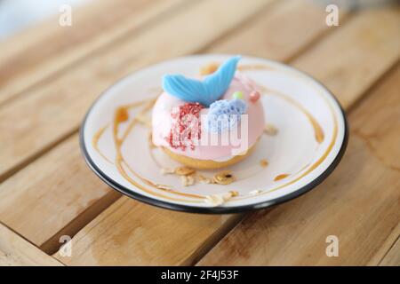 Fancy donut with cute mermaid on top Stock Photo