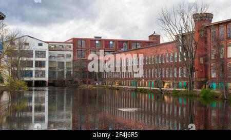 Whitin Machine Works, along the Mumford River, in Whitinsville, MA, It was the largest textile machine manufactory in the world until mid-20th century Stock Photo