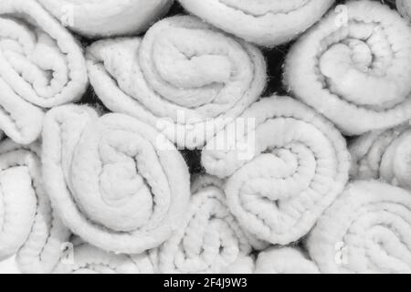 Set of soft white knitted woolen blankets background, close-up. Stock Photo