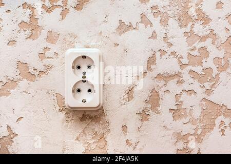 White double power socket on plaster wall in modern room interior. Stock Photo
