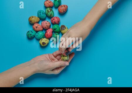 colored eggs for easter and two hands Stock Photo