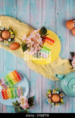 Top view of teapot with piece of cake and brown eggs for Easter party. Stock Photo