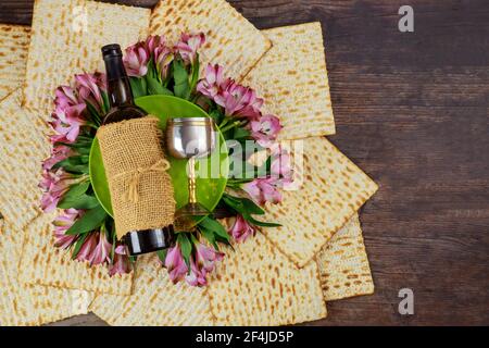 Matzos bread with wine bottle and kiddush cup. Jewish Pesach holiday. Stock Photo