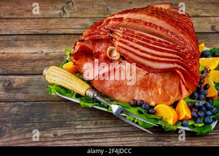 Whole pork ham with fresh fruits. Healthy food. Stock Photo