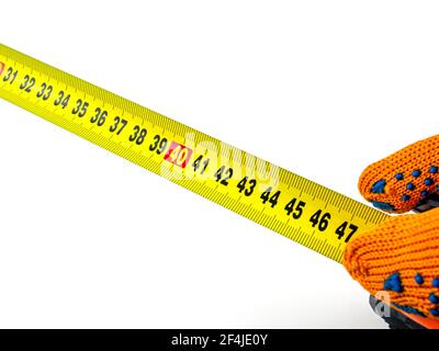 Measuring tape in the hands of a worker. Stock Photo