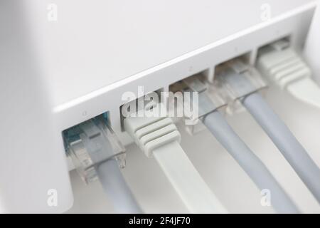 White internet router with connected wires closeup Stock Photo