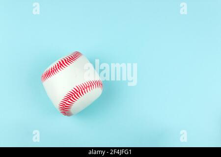 Small white red ball for baseball sport game on blue background Stock Photo