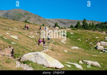Hikers on the trail around the Bouillouses lakes, a natural site in the Capcir region, Catalan Pyrenees Regional Natural Park, Pyrenees-Orientales (66 Stock Photo